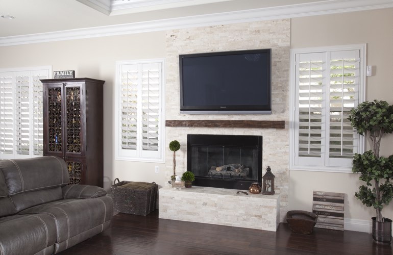 White plantation shutters in a Hartford living room with solid hardwood floors.